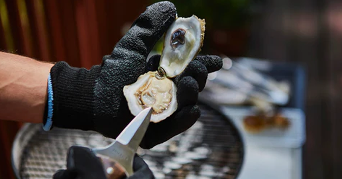 Image showing a busy cook using Oyster Shucking Gloves to prepare a meal.